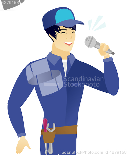 Image of Young asian mechanic singing to the microphone.