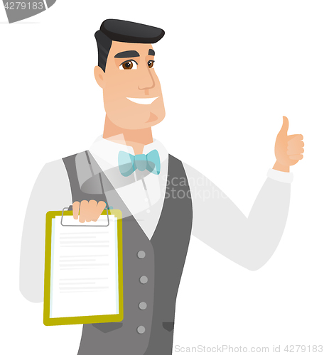 Image of Groom holding clipboard and giving thumb up.