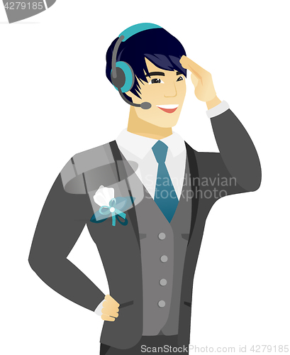 Image of Young asian groom in headset.