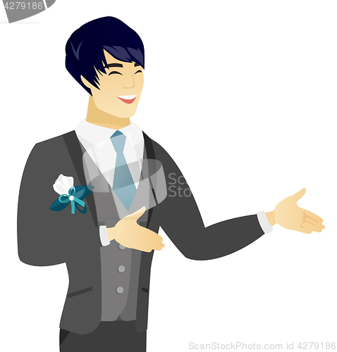 Image of Young asian happy groom gesturing.