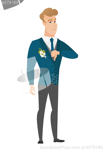 Image of Disappointed caucasian groom with thumb down