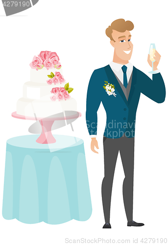 Image of Groom standing near cake with glass of champagne.