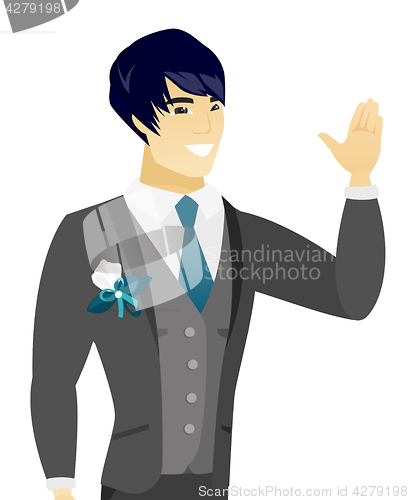 Image of Young asian groom waving his hand.