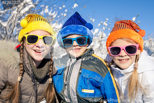 Image of Happy little children playing  in winter snow day.