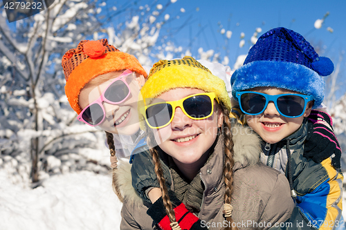 Image of Happy little children playing  in winter snow day.