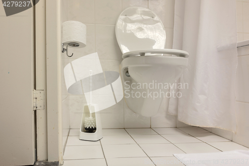 Image of Toilet brush in a simple bathroom