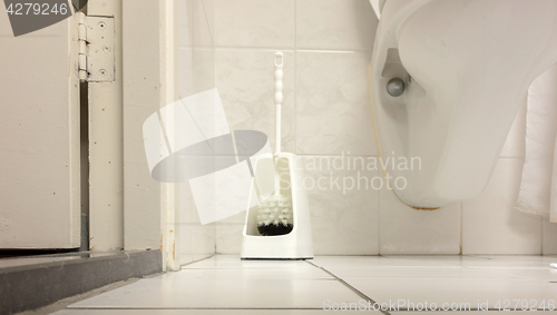 Image of Toilet brush in a simple bathroom