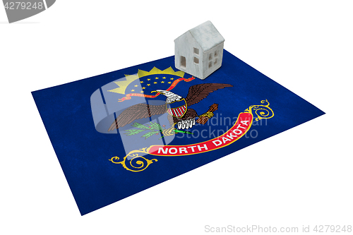 Image of Small house on a flag - North Dakota