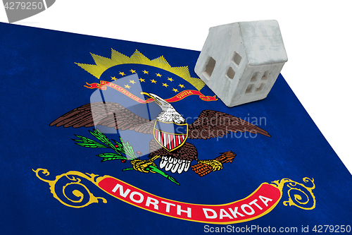 Image of Small house on a flag - North Dakota