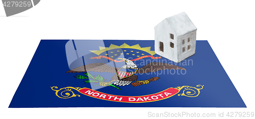 Image of Small house on a flag - North Dakota