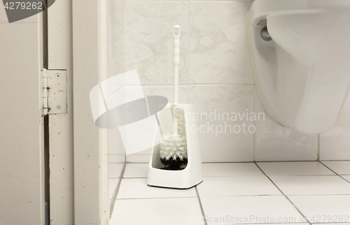 Image of Toilet brush in a simple bathroom