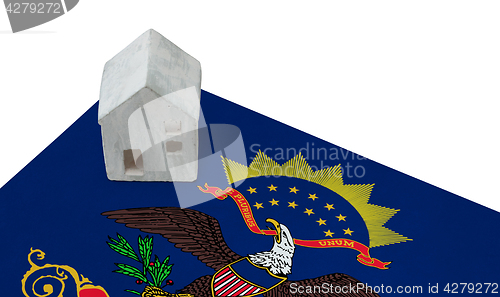 Image of Small house on a flag - North Dakota