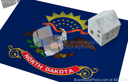 Image of Small house on a flag - North Dakota