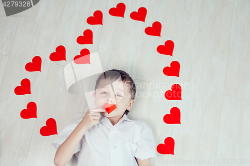 Image of One little boy lying on the floor.