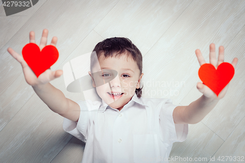 Image of One little boy lying on the floor.