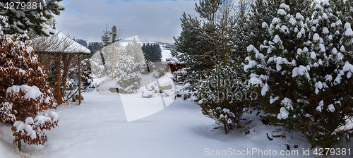 Image of beautiful winter garden covered by snow