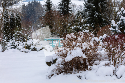 Image of beautiful winter garden covered by snow