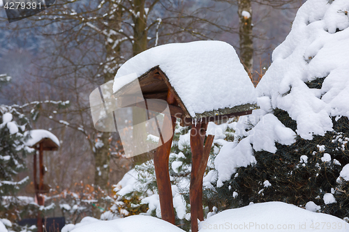 Image of simple bird feeder, birdhouse in winter