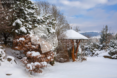 Image of beautiful winter garden covered by snow