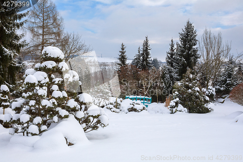 Image of beautiful winter garden covered by snow