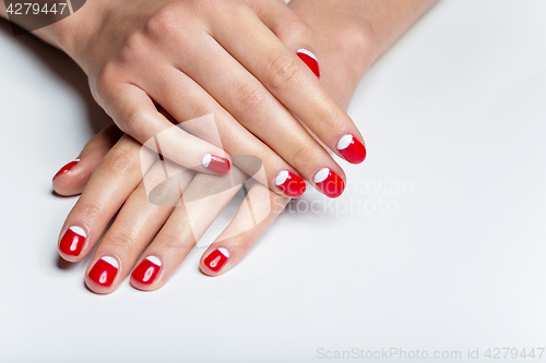 Image of Female hands with red and white nails