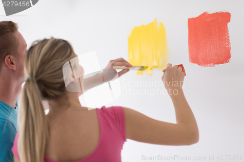 Image of couple painting interior wall