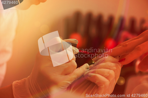 Image of Woman hands receiving a manicure