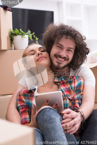 Image of young couple moving  in new house