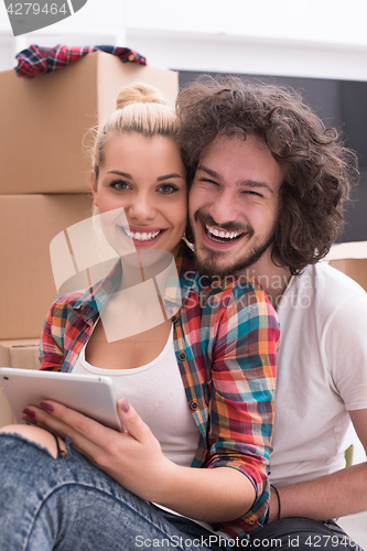 Image of young couple moving  in new house