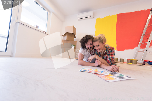 Image of Happy young couple relaxing after painting