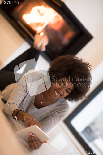 Image of black women using tablet computer on the floor