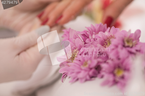 Image of Woman hands receiving a manicure