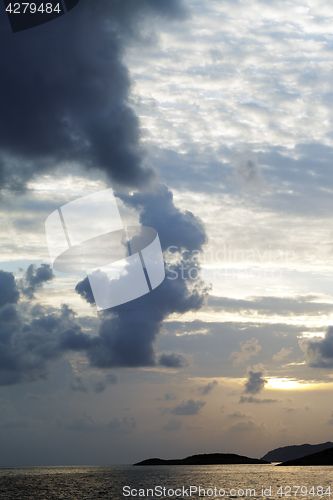 Image of Islands in sea and sky with clouds at sunset