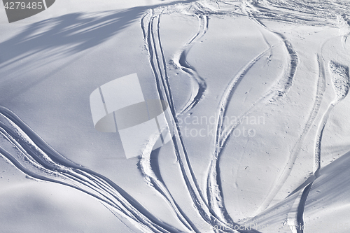Image of Off-piste slope with track from ski and snowboard on sunny eveni