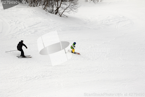 Image of Skiers on ski slope at winter day