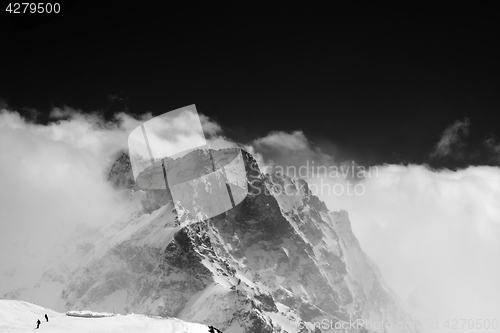 Image of Black and white view on snow mountains in clouds