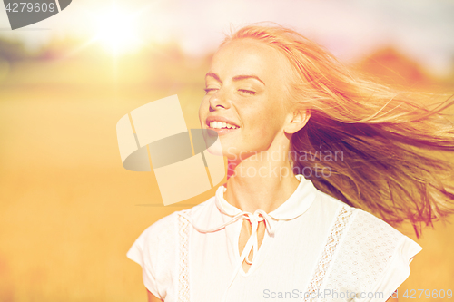 Image of smiling young woman in white on cereal field