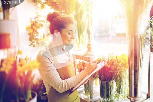 Image of florist woman with clipboard at flower shop