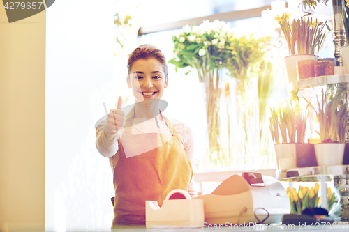 Image of florist woman at flower shop showing thumbs up 