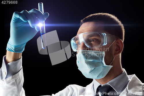 Image of scientist with safety glasses, mask and test tube