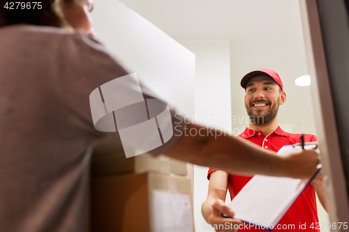 Image of deliveryman and customer with parcel boxes at home