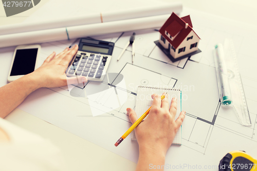 Image of close up of architect hand counting on calculator