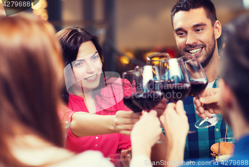 Image of friends clinking glasses of wine at restaurant