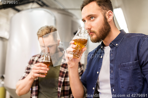 Image of men drinking and testing craft beer at brewery