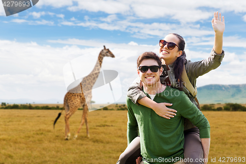 Image of happy couple with backpacks having fun in africa