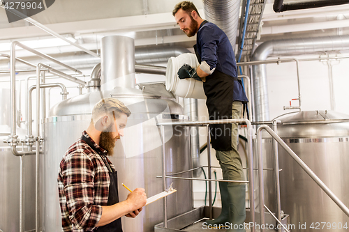 Image of men working at craft brewery or beer plant