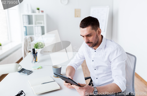 Image of businessman with tablet pc at office