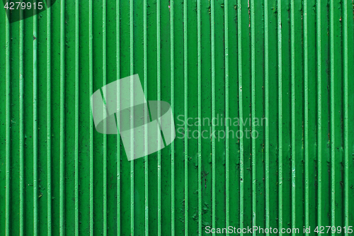 Image of old green painted metal ribbed surface