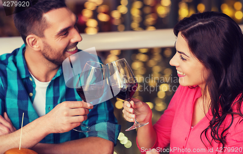 Image of happy couple dining and drink wine at restaurant