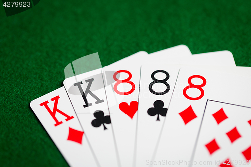 Image of poker hand of playing cards on green casino cloth